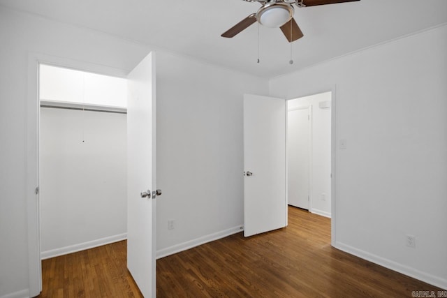 unfurnished bedroom with a closet, ceiling fan, and dark wood-type flooring