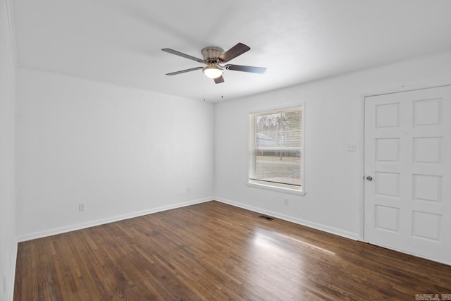 spare room featuring ceiling fan and dark wood-type flooring