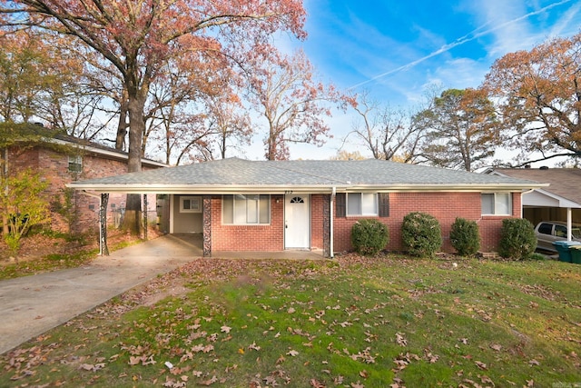 ranch-style house with a front yard and a carport