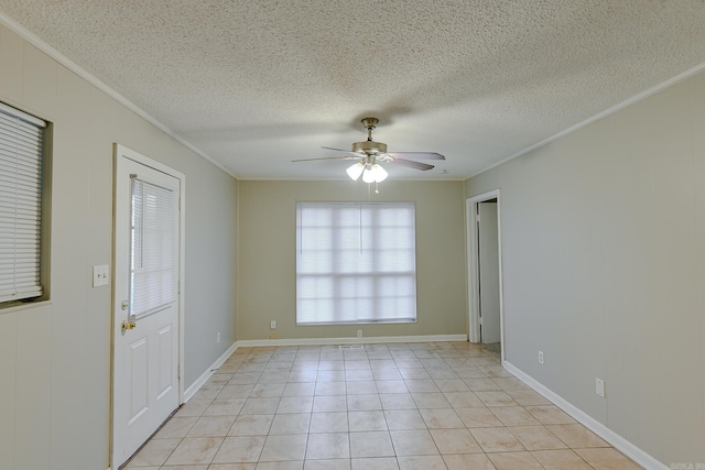 empty room featuring ceiling fan, light tile patterned floors, and a textured ceiling