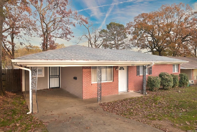 ranch-style house featuring a carport