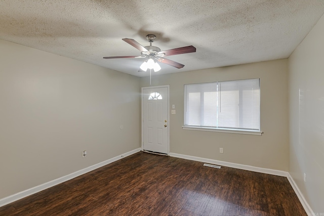 entryway with a textured ceiling, dark hardwood / wood-style floors, and ceiling fan