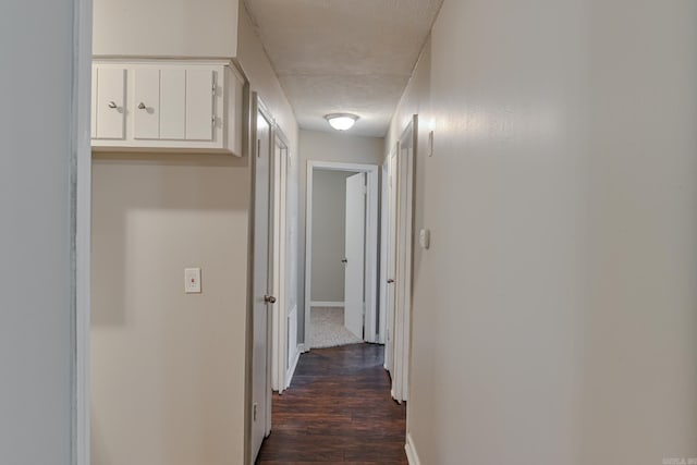 hall featuring dark hardwood / wood-style flooring and a textured ceiling