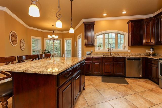 kitchen featuring a kitchen bar, sink, a center island, pendant lighting, and stainless steel appliances