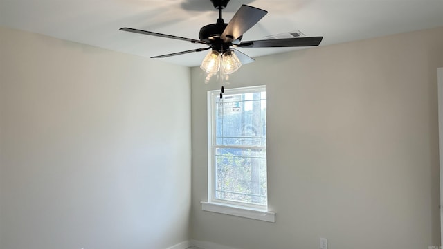 unfurnished room featuring a wealth of natural light and ceiling fan