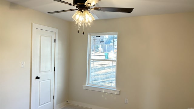 empty room with ceiling fan and plenty of natural light