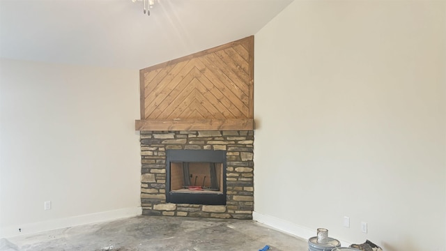 room details featuring concrete floors and a stone fireplace