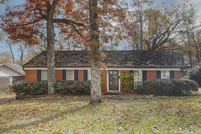 ranch-style home with a front lawn