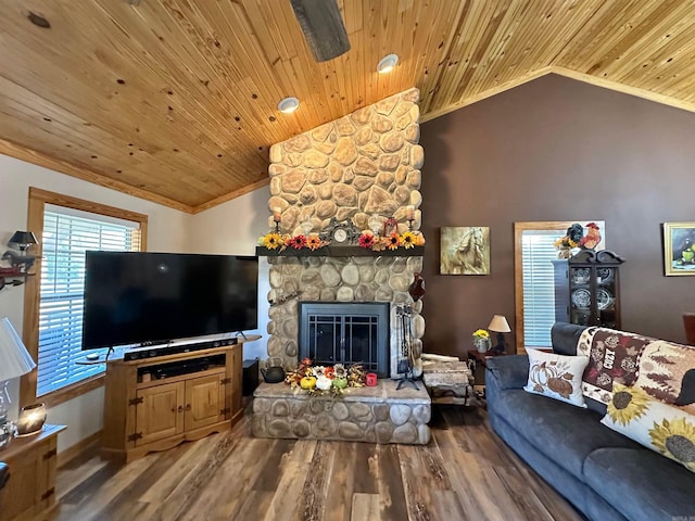 living room with wood ceiling, vaulted ceiling, crown molding, wood-type flooring, and a stone fireplace