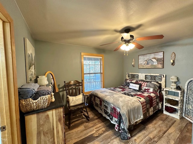 bedroom featuring dark hardwood / wood-style floors and ceiling fan