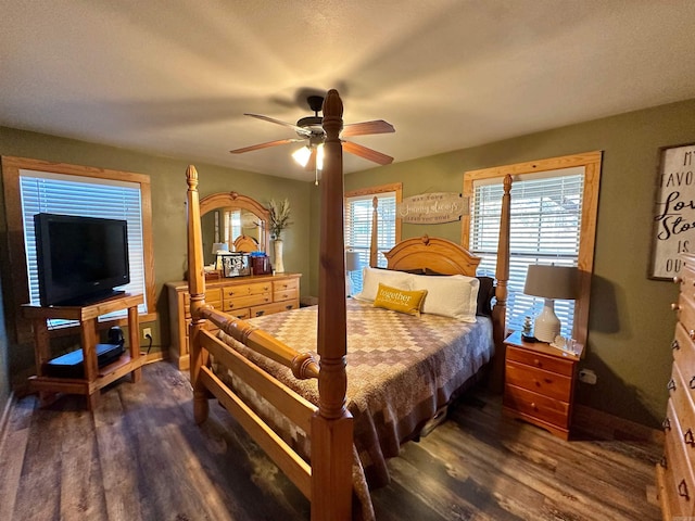 bedroom with dark hardwood / wood-style floors and ceiling fan