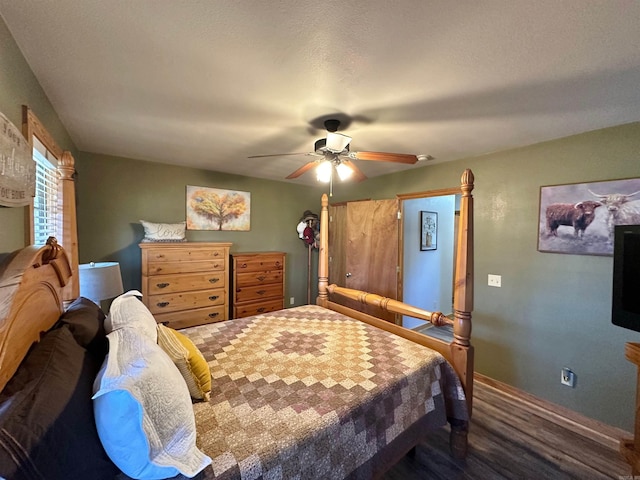 bedroom with ceiling fan and dark wood-type flooring