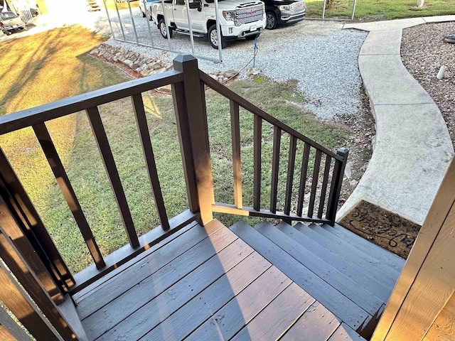 wooden deck with a lawn