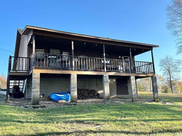 rear view of house with a lawn and a wooden deck