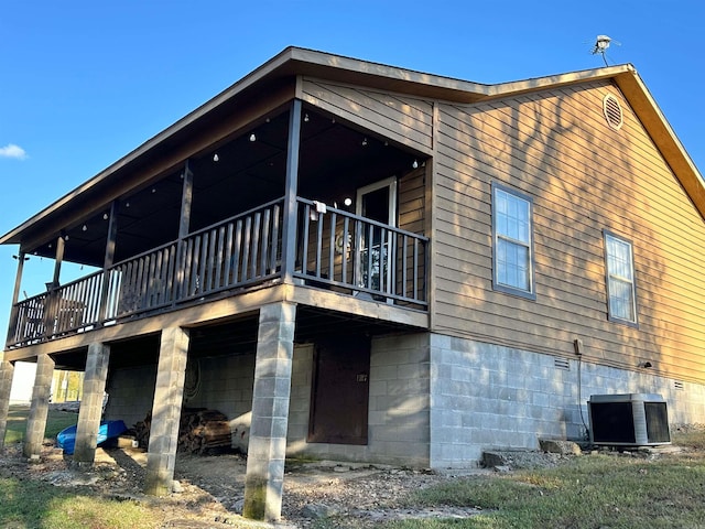 back of house with central AC and a balcony