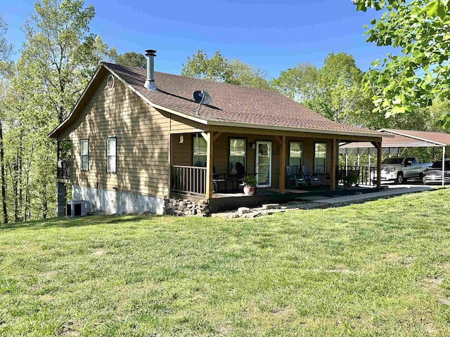 rear view of house featuring a porch, a lawn, central AC unit, and a carport
