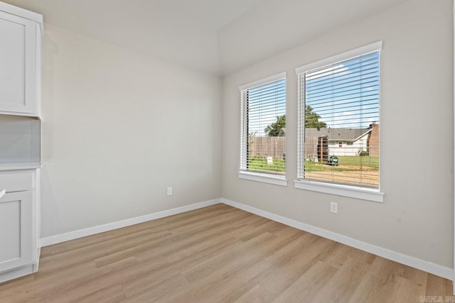 empty room with light hardwood / wood-style flooring