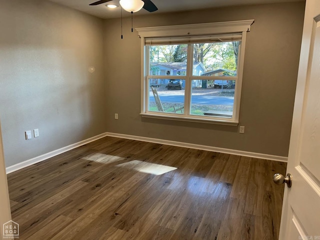 unfurnished room with ceiling fan and dark hardwood / wood-style flooring