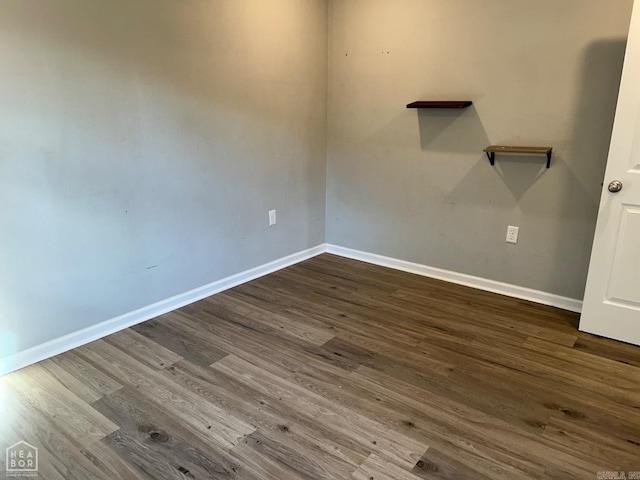 spare room featuring dark wood-type flooring