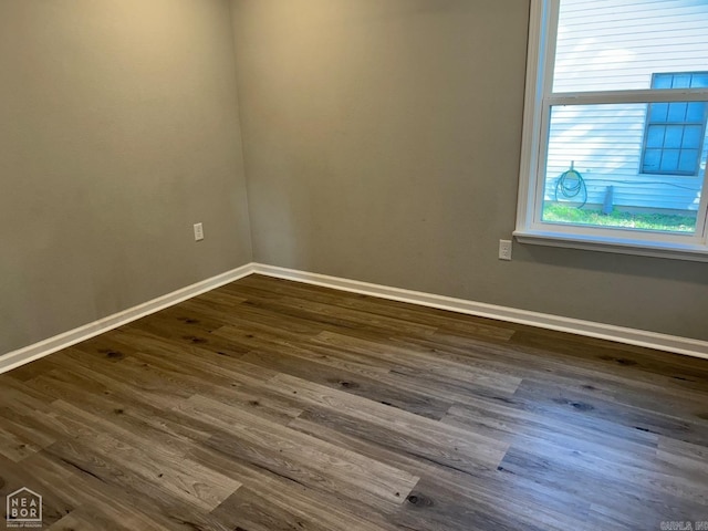 unfurnished room featuring dark hardwood / wood-style flooring