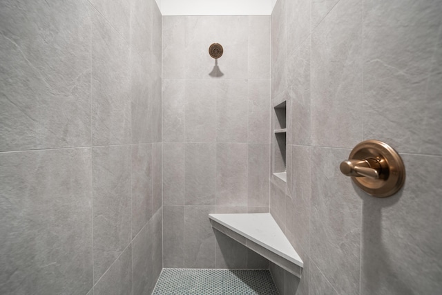 bathroom with a tile shower