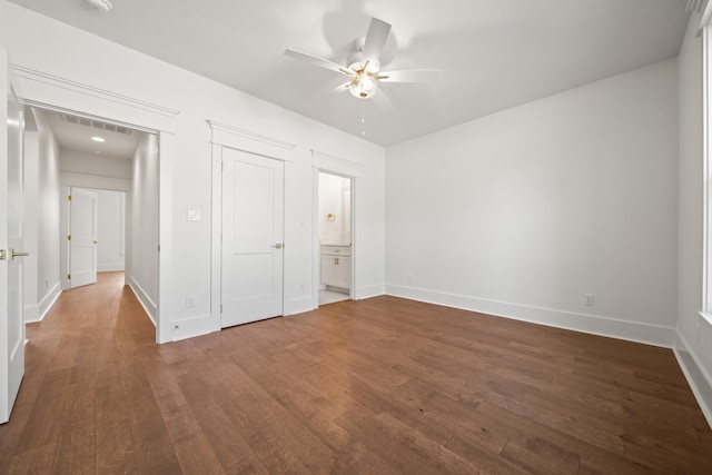 unfurnished bedroom with dark hardwood / wood-style floors, ceiling fan, and a closet