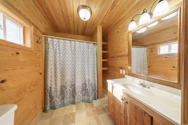 bathroom with plenty of natural light, wood walls, and wood ceiling