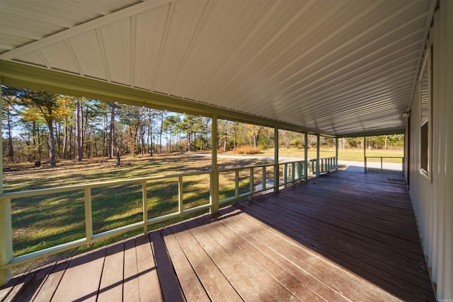 wooden deck featuring a lawn