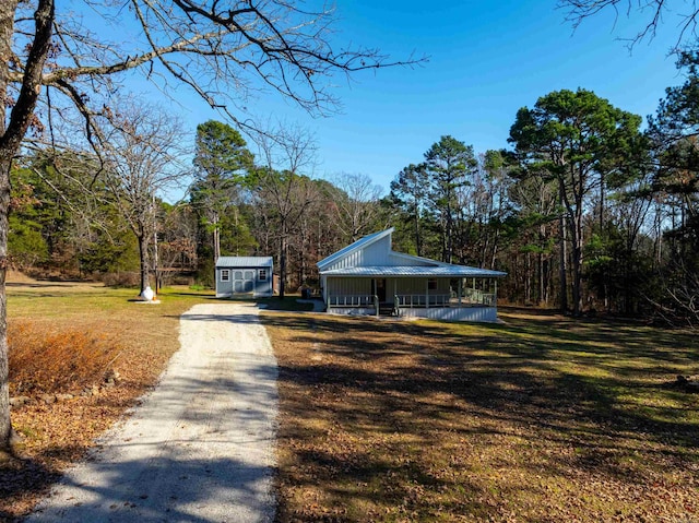 view of community featuring an outdoor structure and a yard