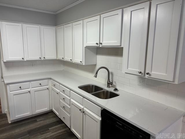 kitchen with dishwasher, dark wood-type flooring, crown molding, sink, and white cabinetry