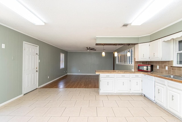 kitchen featuring dishwasher, ceiling fan, white cabinetry, and tasteful backsplash