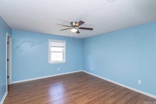 unfurnished room featuring ceiling fan, dark wood-type flooring, and a textured ceiling