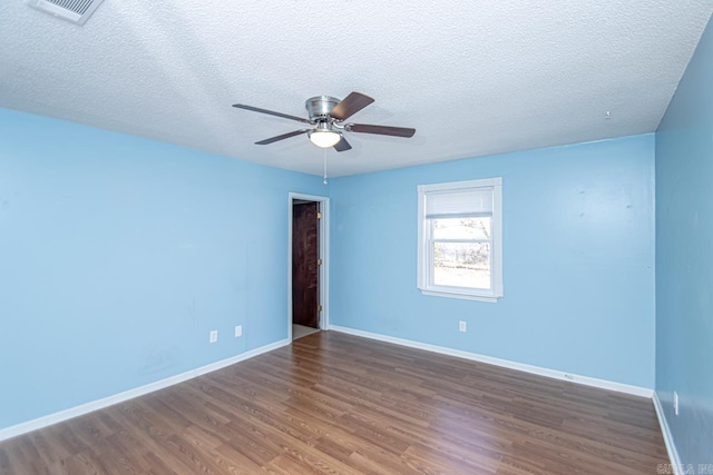 unfurnished room featuring a textured ceiling, ceiling fan, and dark wood-type flooring