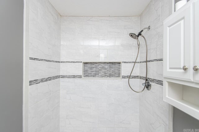 bathroom with tiled shower