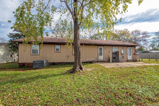 back of house featuring a yard, a patio area, and central air condition unit