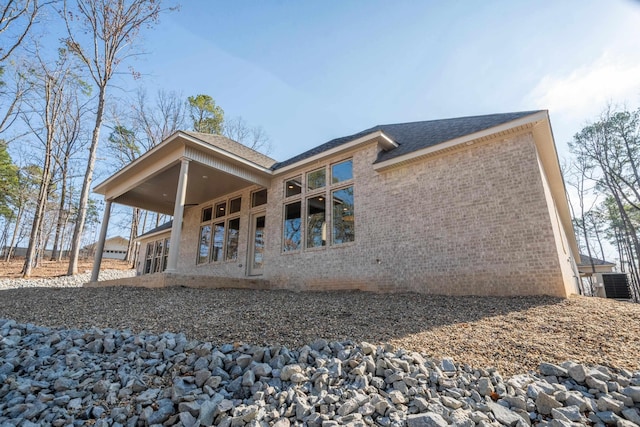 back of property featuring central AC