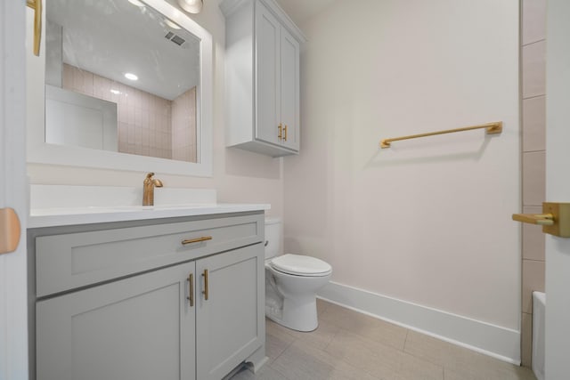 bathroom featuring tile patterned floors, vanity, and toilet