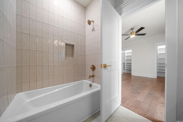 bathroom with tiled shower / bath combo, ceiling fan, and hardwood / wood-style flooring