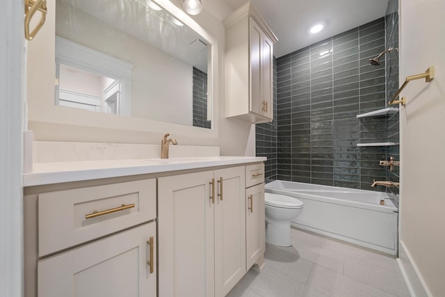 full bathroom with tile patterned flooring, tiled shower / bath, vanity, and toilet