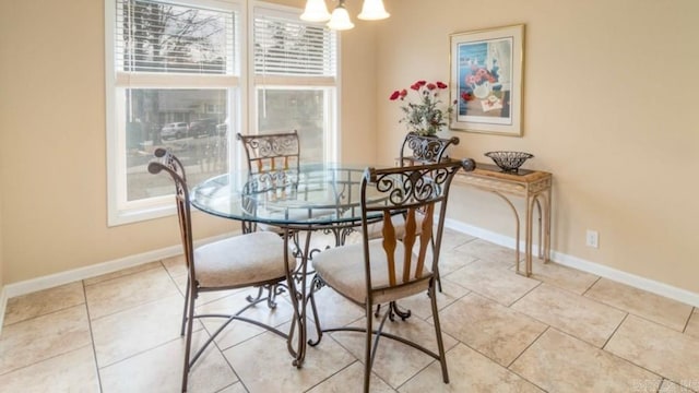 dining space with light tile patterned flooring and a chandelier