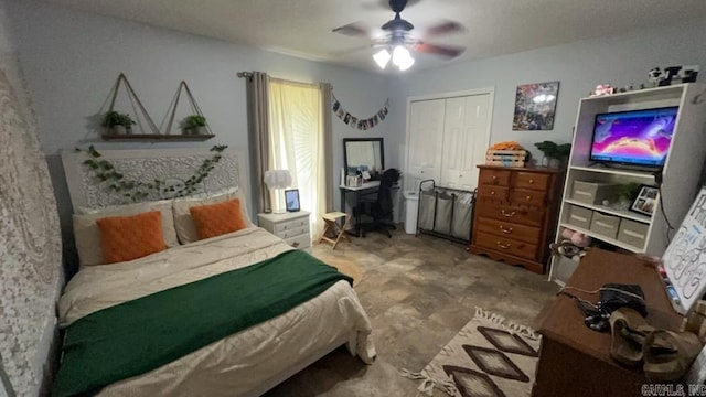 bedroom with ceiling fan and a closet