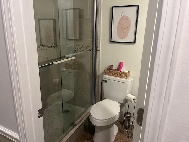 bathroom featuring toilet and walk in shower