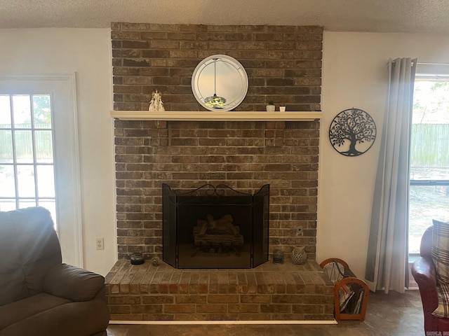 room details with a textured ceiling and a brick fireplace