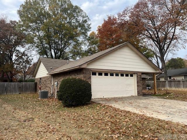 view of home's exterior featuring a garage and central AC