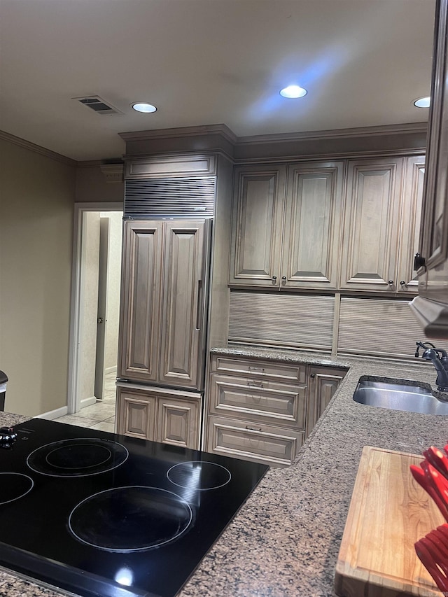 kitchen with black appliances, crown molding, sink, and light stone countertops