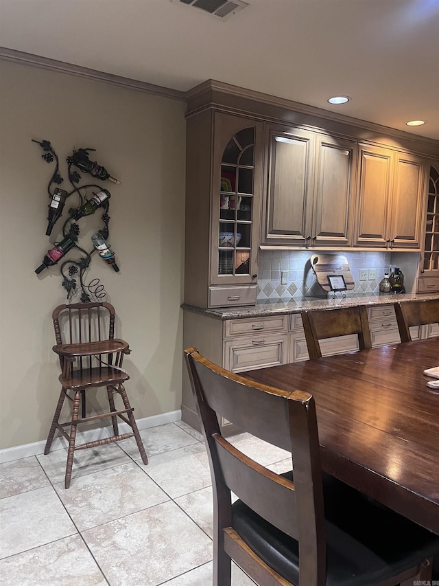 tiled dining space with ornamental molding