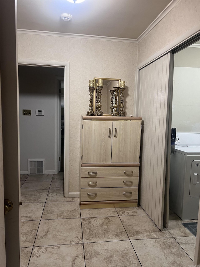 interior space featuring washer / dryer and ornamental molding