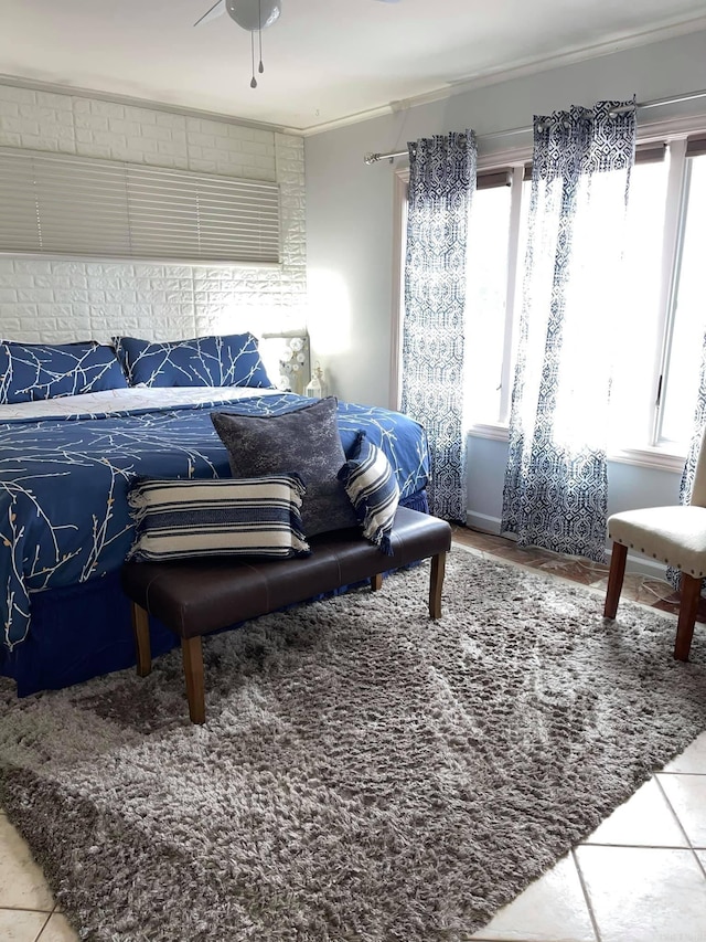 bedroom featuring tile patterned floors, ceiling fan, and ornamental molding