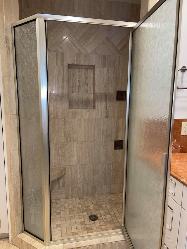 bathroom featuring a shower with door