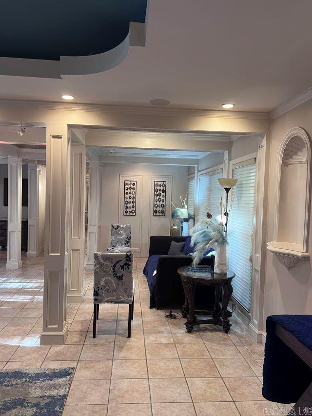 interior space featuring crown molding and light tile patterned flooring